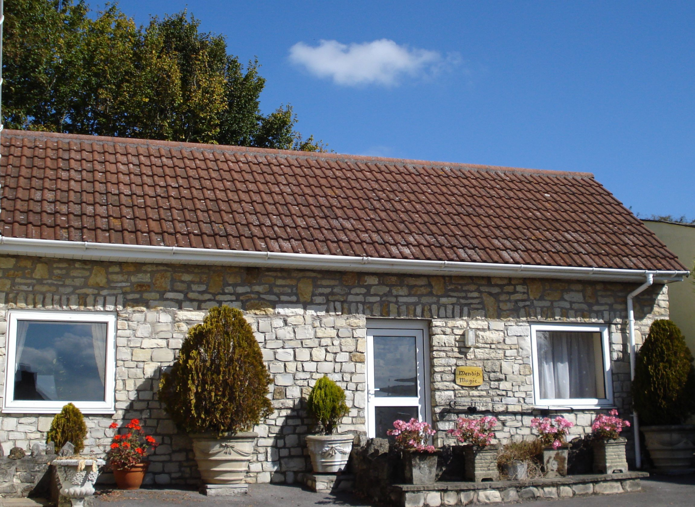 Front summer view with geranium pots